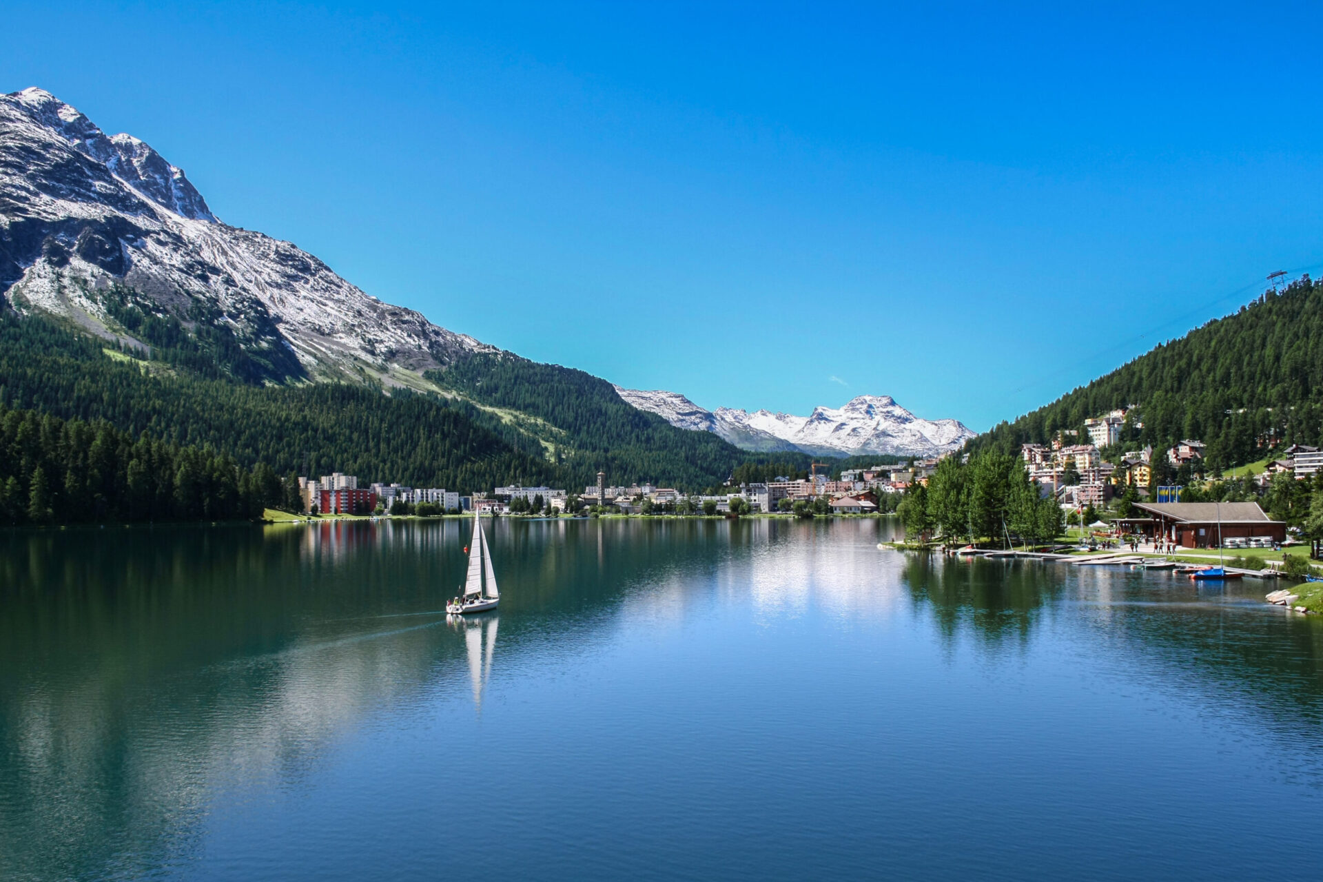 View of Saint Moritz lake with small boat st moritz umzug mit Fuhrmann